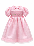 Pink smocked dress with polka dot tulle layer