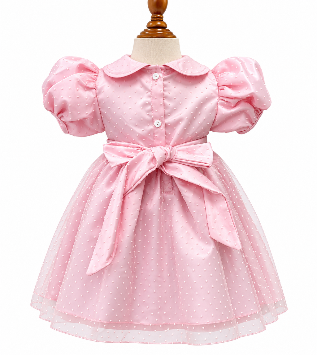 Pink smocked dress with polka dot tulle layer